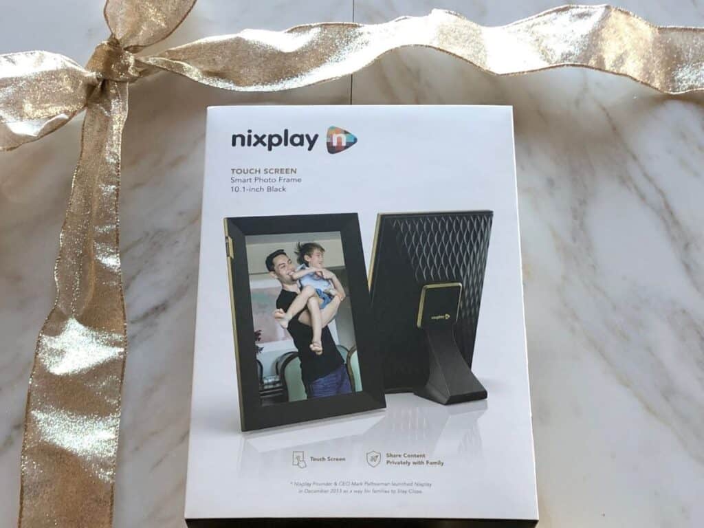 nixplay digital photo frame in its box with a gold ribbon