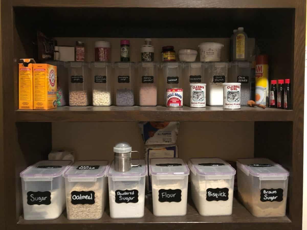 a pantry shelf with baking products like flour sugar and baking soda