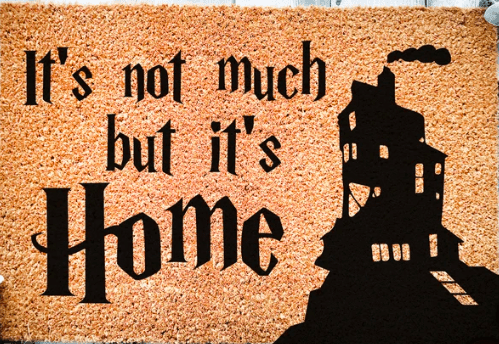a doormat with Ron Weasleys home and the words that say its not much but its home