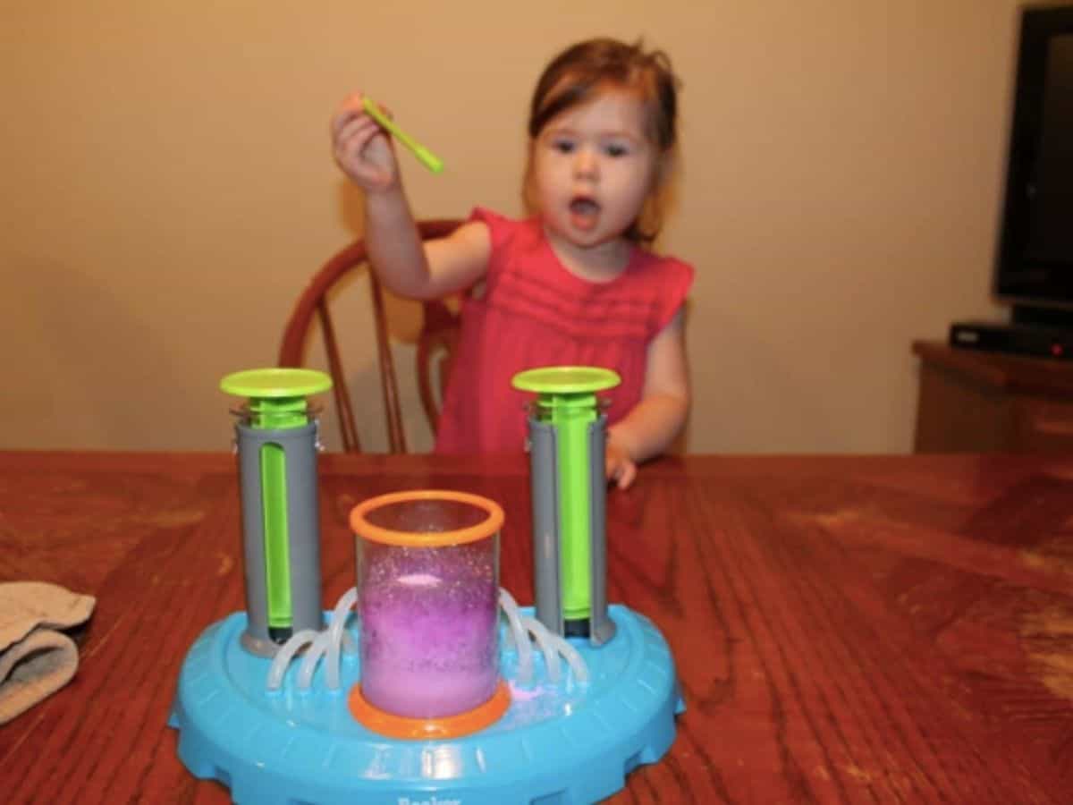 a child playing with the beaker creatures lab set