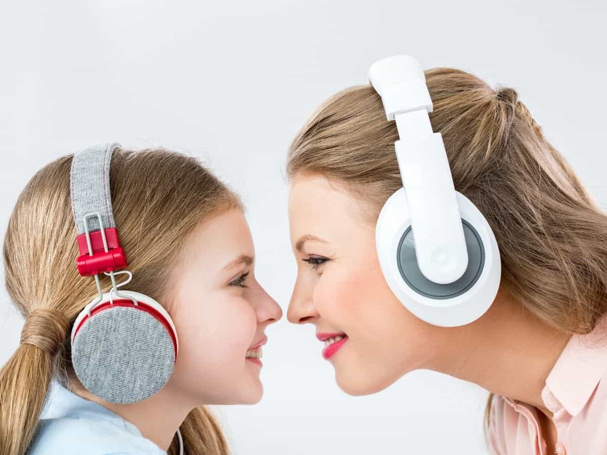 a mom and her daughter both wearing headphones