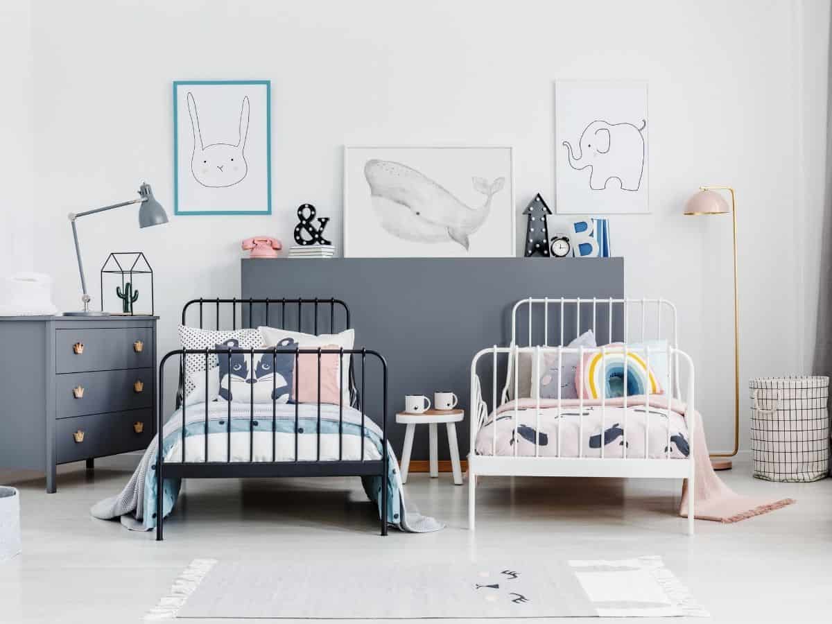 two metal twin size beds in a kids shared bedroom