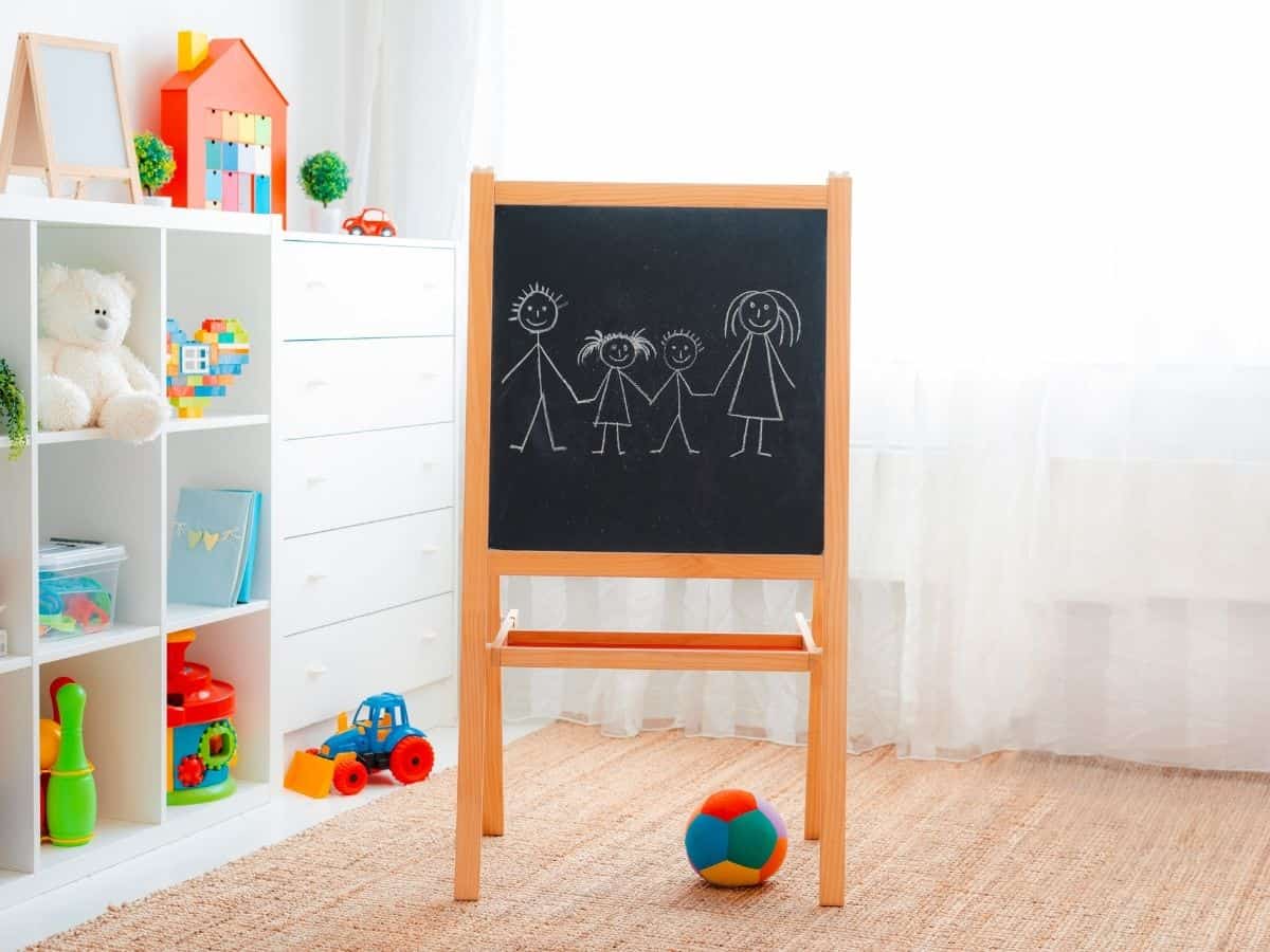 a toy room with a chalkboard and some toy storage