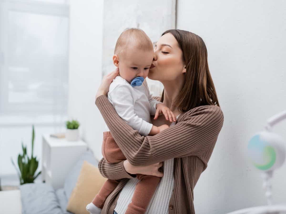 a mom with her baby who has a pacifier