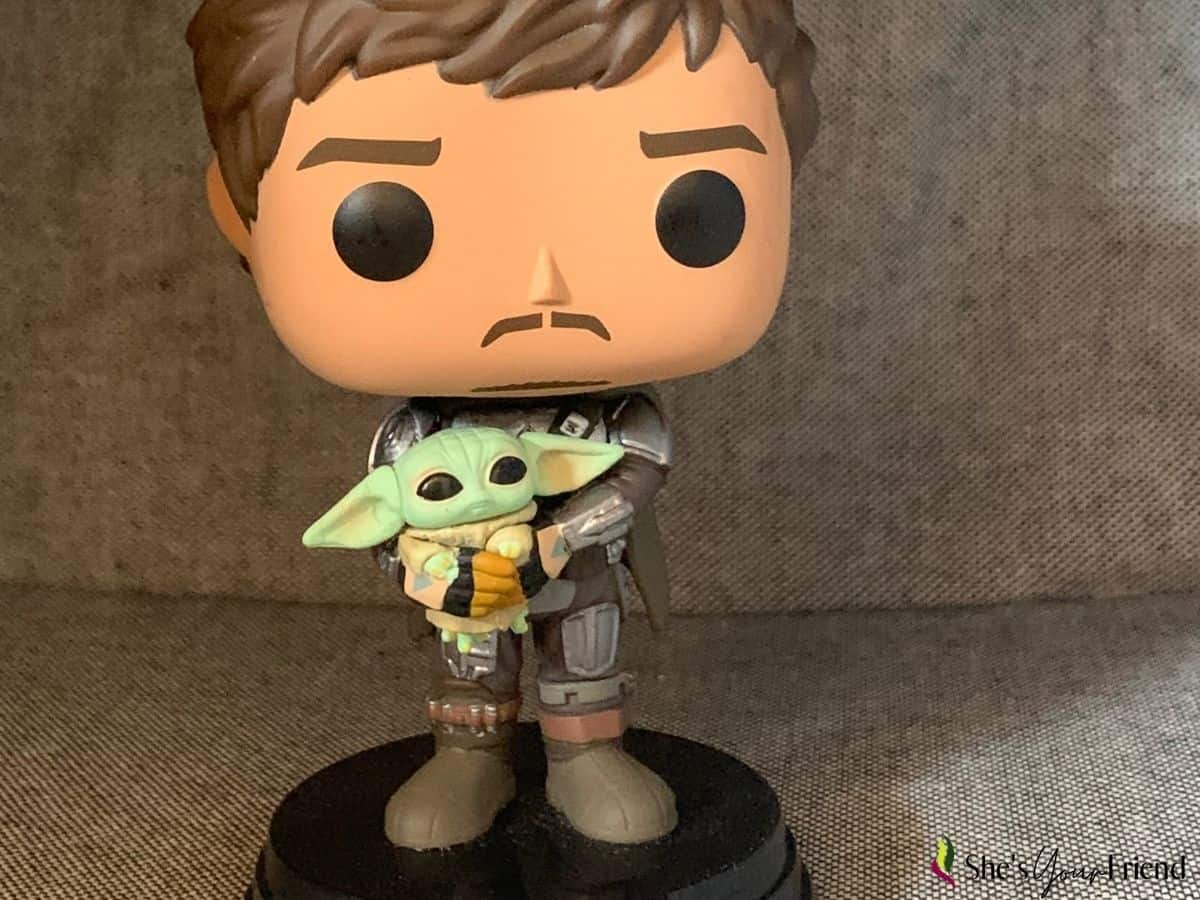 a funkopop figurine of the mandalorian and grogu from the star wars spin off The mandalorian