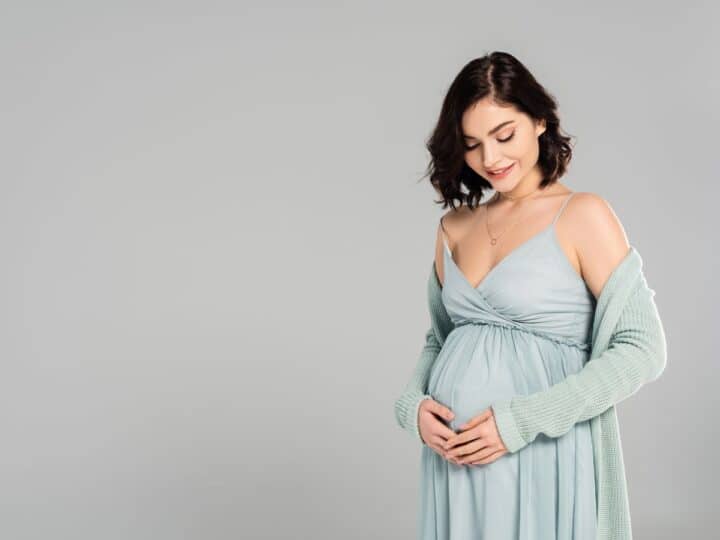a pregnant woman wearing a dress