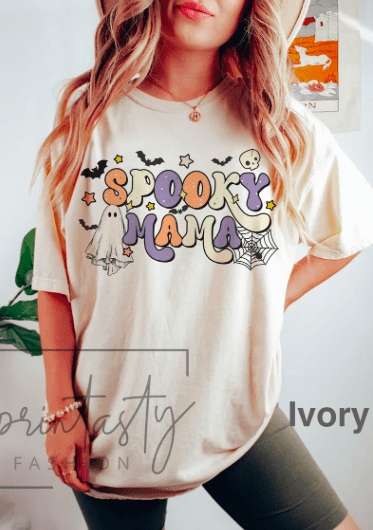 a woman wearing a graphic tee that says spooky mama
