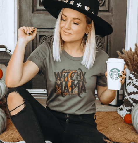 a woman wearing a shirt that says witchy mama