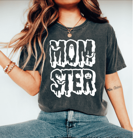 a woman wearing a gray shirt that says momster