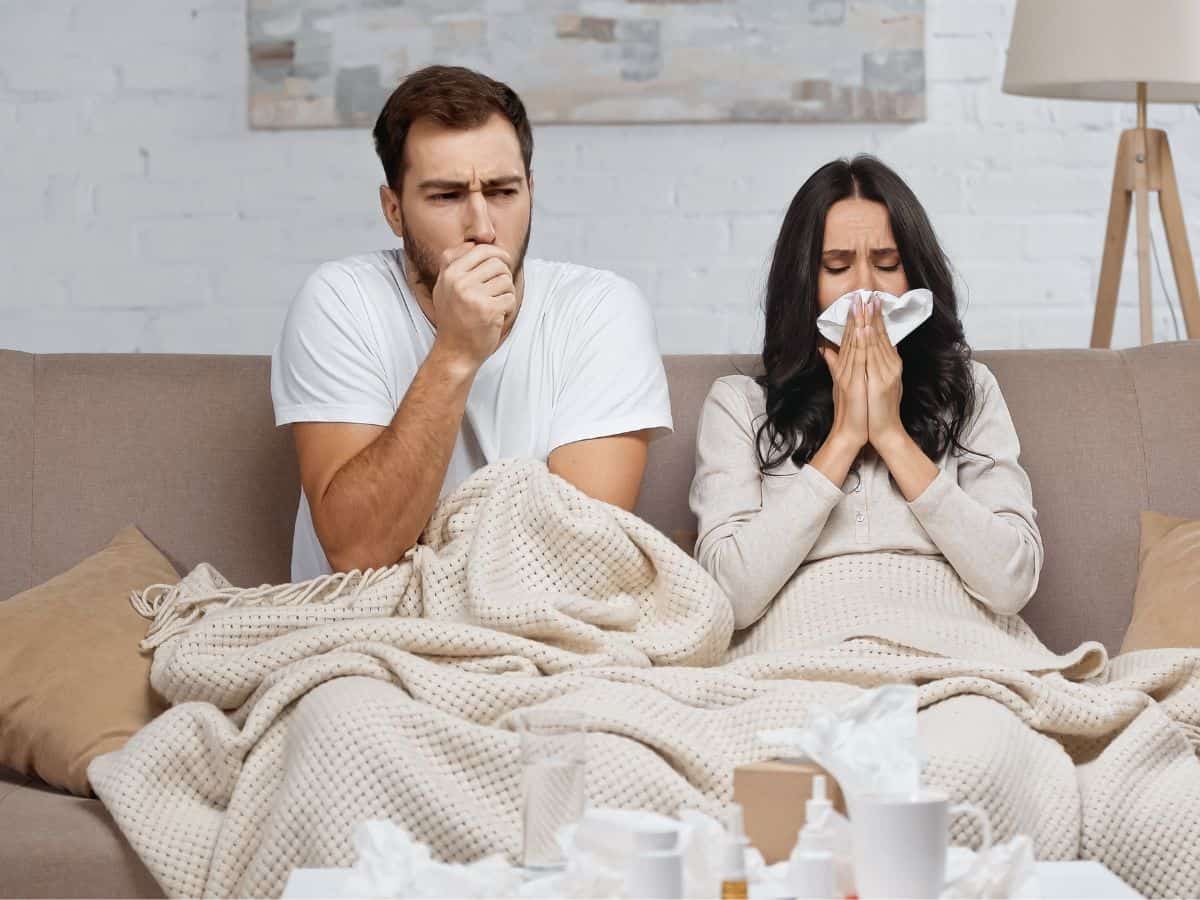 a woman and a man on a cough who look sick