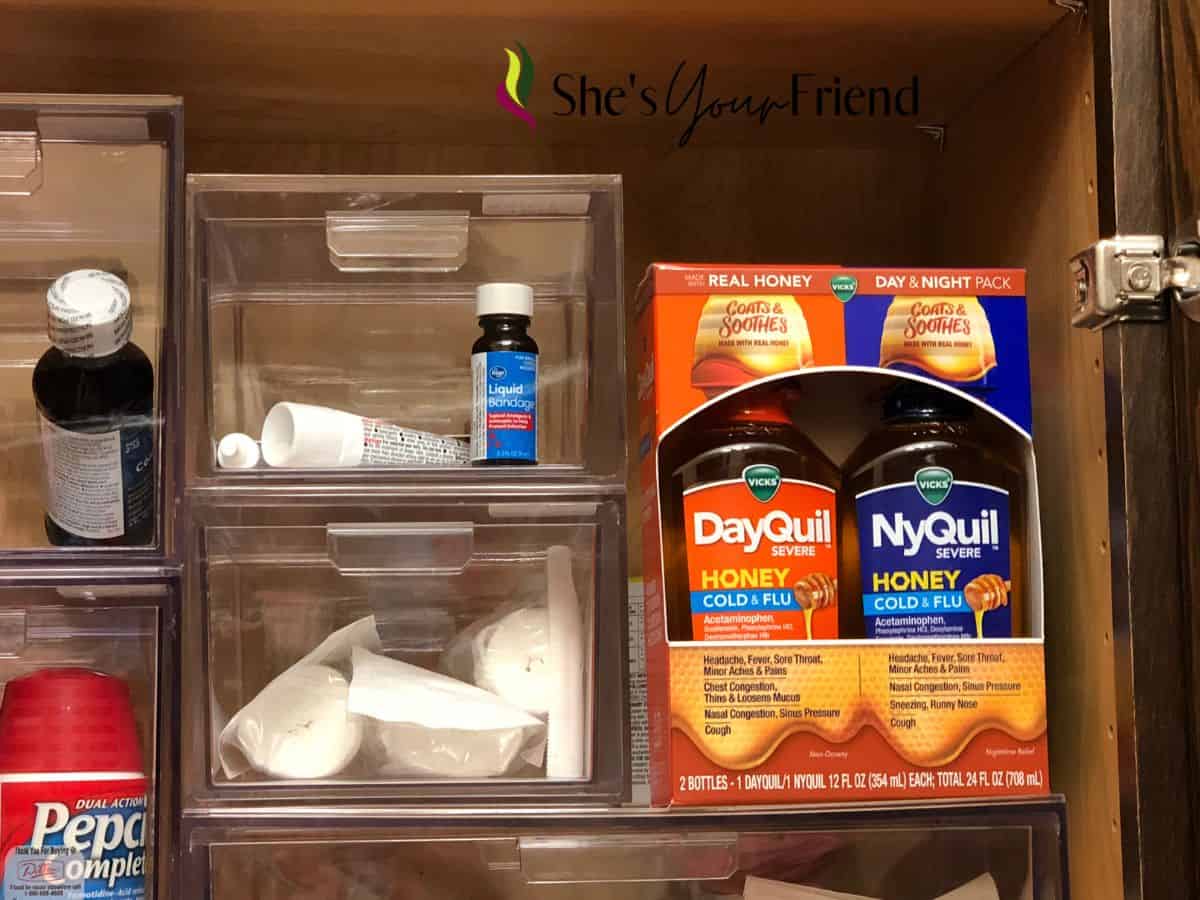 a medicine cabinet with DayQuil and NyQuil in it