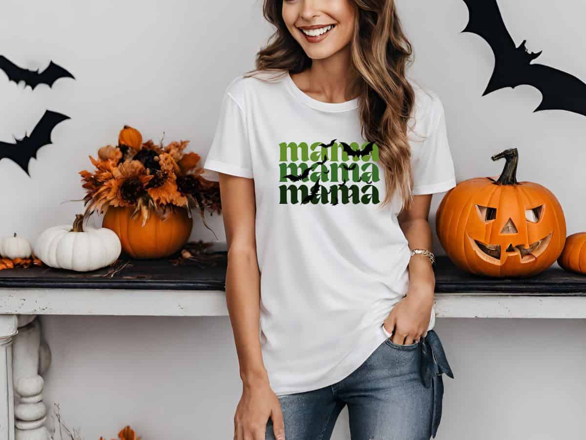 a woman wearing a shirt that says mama mama mama and has bats on it