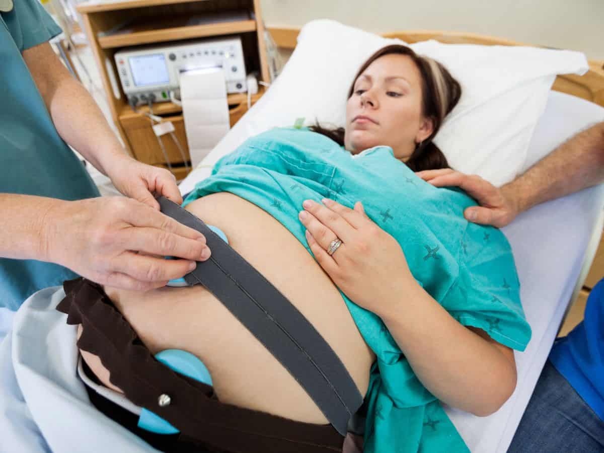a mom getting her baby monitors on her belly for induction