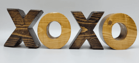 stained wood shaped like the letters x and o