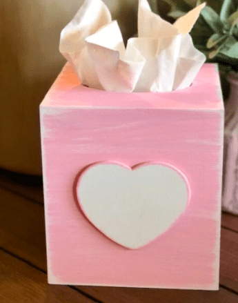 a pink tissue box cover with a white heart