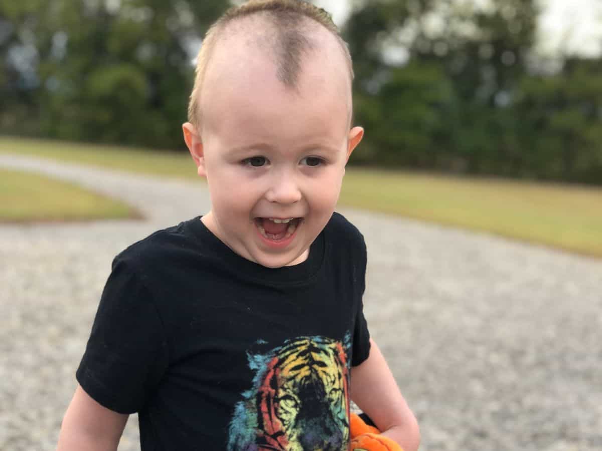 a happy boy wearing a tiger shirt