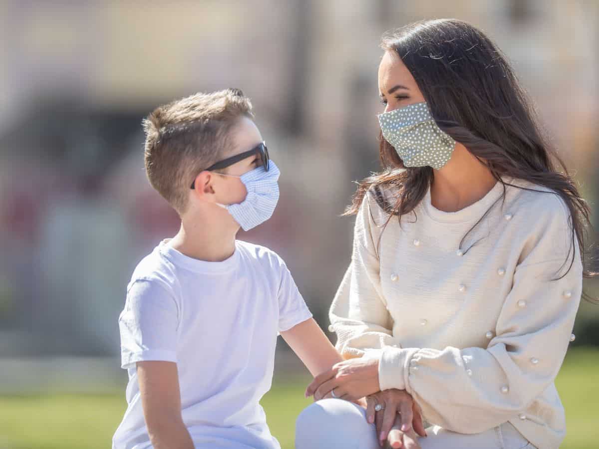 a mom and son both wearing cloth face masks