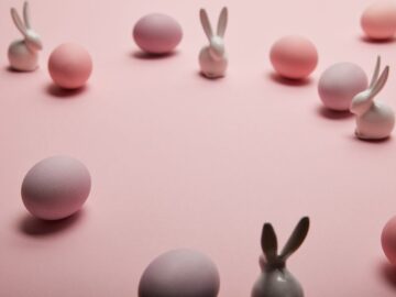 a pink background with easter eggs and bunnies