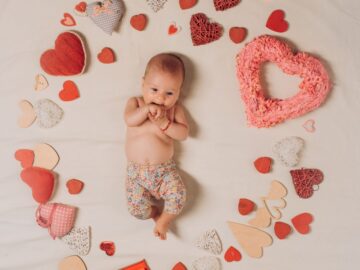 a baby surrounded by hearts
