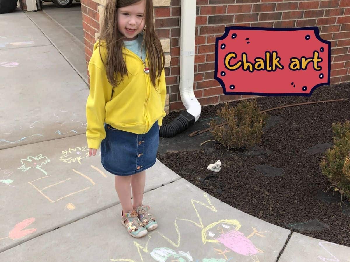 a little girl posing next to her sidewalk chalk art and text overlay that reads chalk art