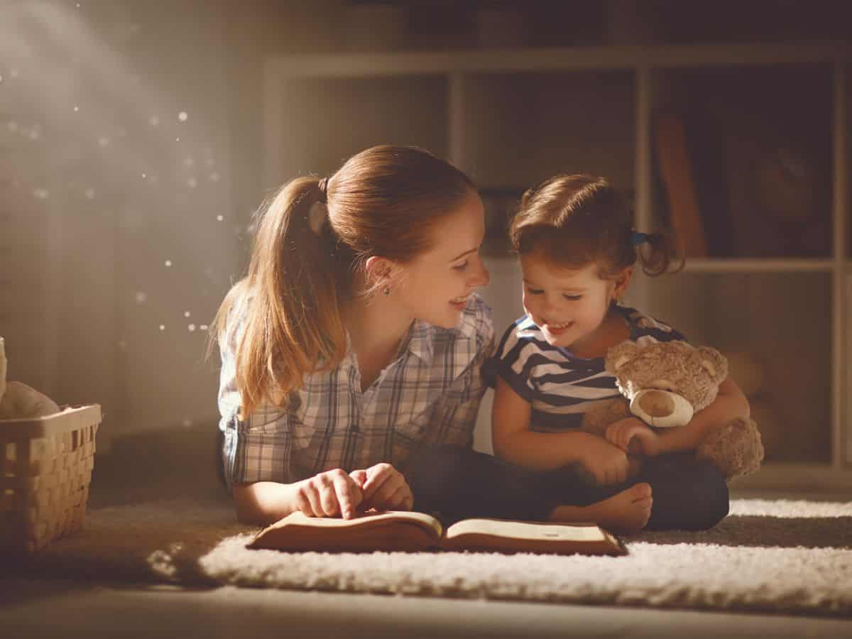 a mom reading to her daughter