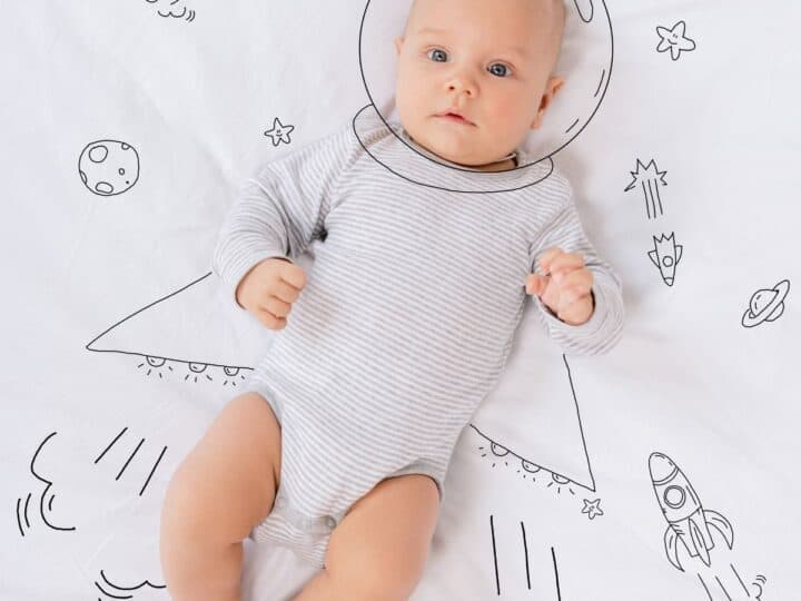 a baby with overlay drawings that look like an astronaut