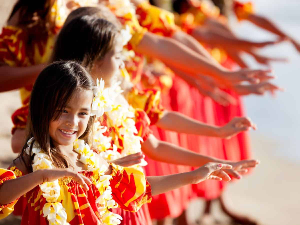 a bunch of girls learning how to hula dance