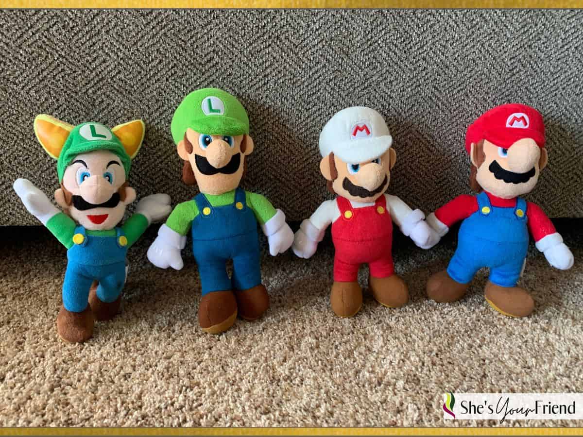 two mario plushes and two luigi plushes