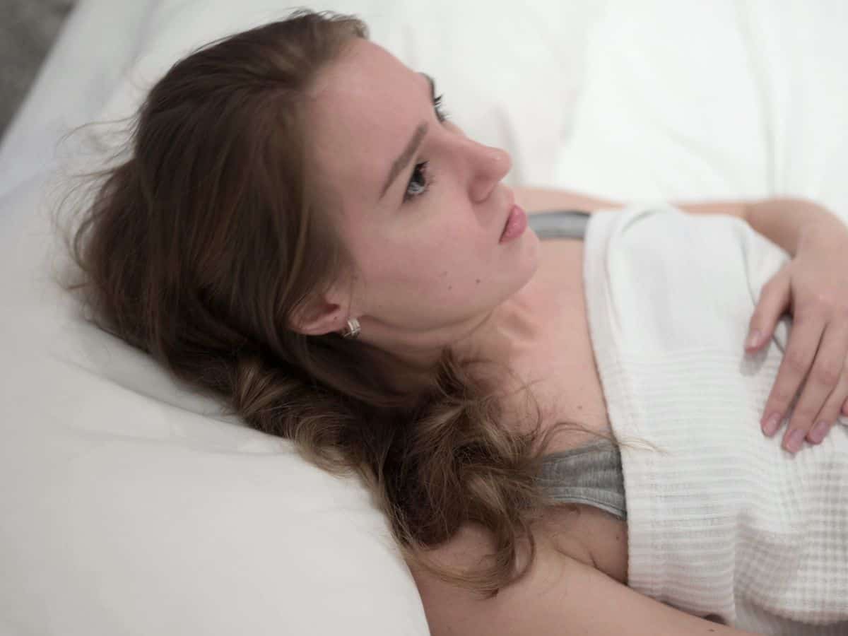 a woman laying on a table looking uncomfortable