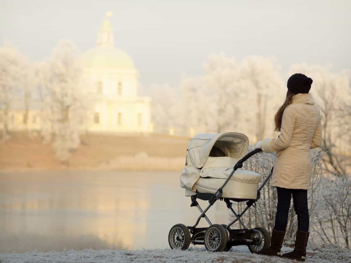 a woman dressed warmly pushing a stroller