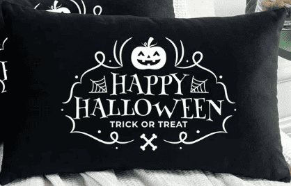 a black pillow that says happy halloween trick or treat