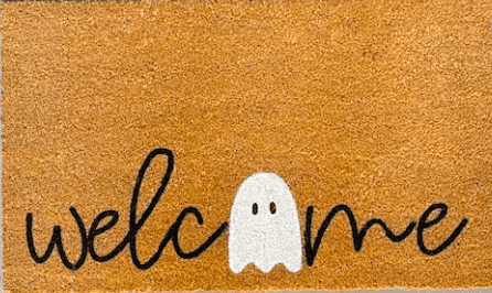 a doormat that says welcome and has a ghost